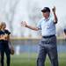 An umpire calls time to discuss a con traversal play in the first game between Saline and Chelsea on Monday, April 29. Daniel Brenner I AnnArbor.com